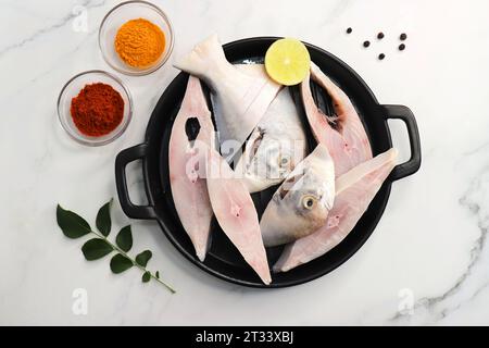 Frischer ganzer Silver Pomfret Fisch oder Butterfisch oder Poplet in Scheiben geschnitten. Gereinigt und bereit zum Frittieren zusammen mit Gewürzen. Zutaten und Rezept Stockfoto