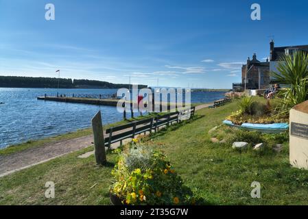 Blick nach Norden vom historischen Findhorn-Dorf entlang der Küste der berühmten Findhorn-Bucht. Boote in der Bucht, Flut voll rein. Binnenmündung am Moray Firth, Stockfoto