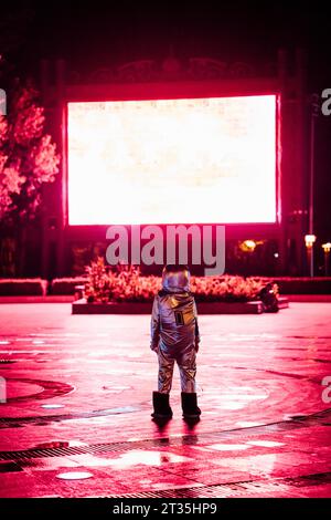 Spaceman auf einem Platz in der Nacht von strahlenden Projektionsfläche angezogen Stockfoto