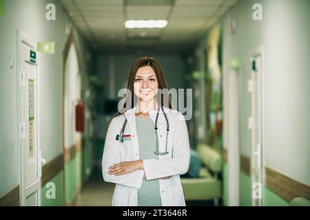 Ärztin mit überkreuzten Armen in der Klinik stehend Stockfoto