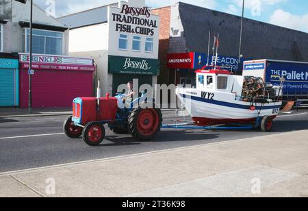 Fisherman fährt einen Traktor, der sein Boot WY2 Harvester nach einem Krabben - oder Hummer - Angelausflug vor Redcar Cleveland UK schleppt Stockfoto