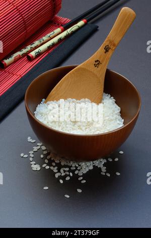 Reis, weißer Reis in einer Schüssel mit Holzkelle, ungekocht Stockfoto