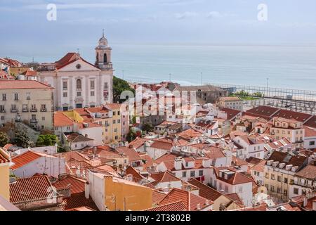 Skyline-Blick auf die Kirche Igreja de Santo Estêvão im barocken Stil des Viertels Alfama und den Fluss Tejo in Lissabon, Portugal. Stockfoto