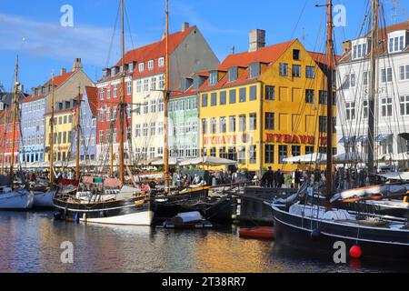 Kopenhagen, Dänemark - 22. Oktober 2023: Blick auf die Uferpromenade des Stadtteils Nyhavn mit alten Gebäuden und Booten. Stockfoto