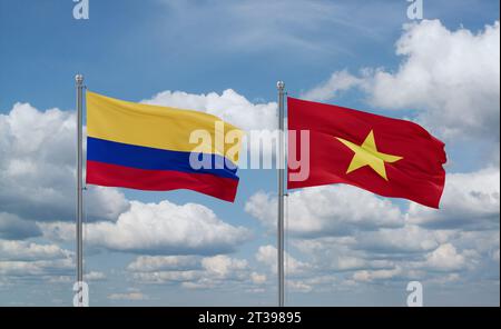 Vietnam- und Kolumbien-Flaggen winken zusammen im Wind auf blauem bewölktem Himmel Stockfoto