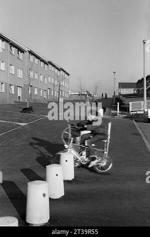 Junge auf einem Raleigh Chopper Bike auf einer Straße mit neu gebauten Häusern während der Slumräumung und des Abbruchs von St Ann's, Nottingham. 1969-1972 Stockfoto