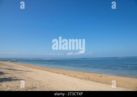 Morgenlandschaft am Sandstrand. Blick über das Meer auf den Vulkan Mount Agung. Panorama des Sonnenaufgangs am Sandstrand von Sanur Stockfoto