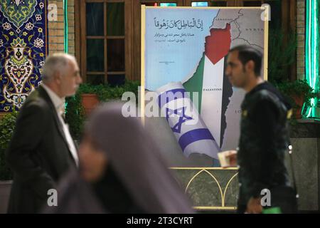 Teheran, Iran. Oktober 2023. Iranische Muslime gehen während einer Gebetszeremonie neben einem anti-israelischen Plakat, um Solidarität und Unterstützung für Gaza am heiligen Schrein von Imamzade Saleh im Norden Teherans zum Ausdruck zu bringen. (Kreditbild: © Rouzbeh Fouladi/ZUMA Press Wire) NUR REDAKTIONELLE VERWENDUNG! Nicht für kommerzielle ZWECKE! Stockfoto