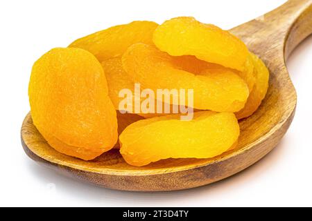 Getrocknete und getrocknete Aprikose in brasilien in rustikalem Holzlöffel, isolierter weißer Hintergrund. Stockfoto