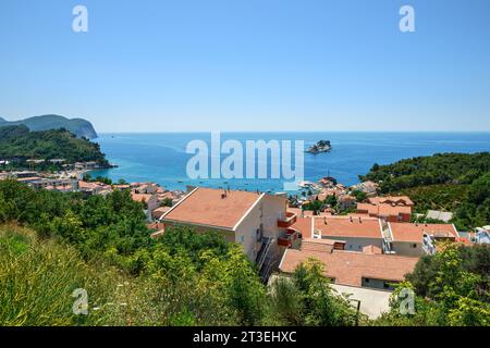 Blick aus einem hohen Winkel auf die Stadt Petrovac mit den beiden Inseln Katic (Katich) und Sveta Nedjelja und der Küstenfestung Castello, Montenegro. Stockfoto