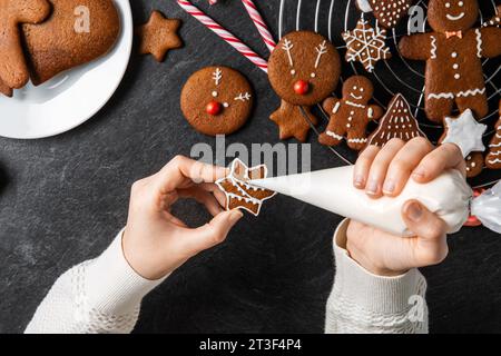 Nahaufnahme der Hände, die Lebkuchenkleckse gefrieren Stockfoto