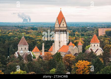 Die 60 m hohe Kapelle am Südfriedhof, Leipzig, erhebt sich über Herbstbäumen. Eröffnung 1910. Das Kraftwerk Lippendorf ist dahinter zu sehen Stockfoto