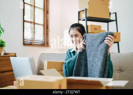 Schöne asiatische Frau, Blogger, Blog, Modebekleidung präsentieren, Live-Video, Soziale Medien, Aufnahme, Online-Verkauf über Digitalkameras, kmu oder kleine unternehmen Stockfoto