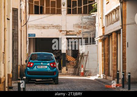 Ein kompaktes Auto parkt in einer ruhigen Straße in der alten ummauerten Stadt Nikosia, Zypern Stockfoto