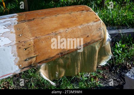 Bootsreparatur. Tragen Sie Harz auf das Boot auf. Klebriges Material. Reparatur eines Schwimmschiffes. Stockfoto