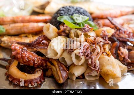 Gerösteter gemischter Fisch und Meeresfrüchte-Teller mit Calamari-Tintenfischen, Garnelen und gegrilltem Oktopus, mediterrane Küche Stockfoto