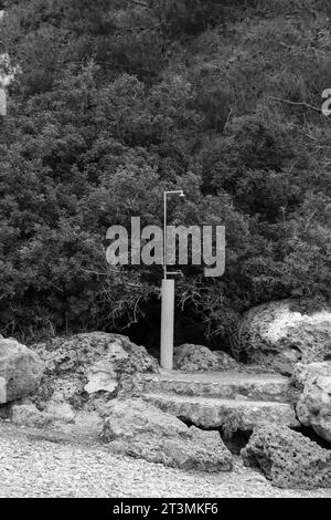 Schwarz-weiß isolierter Außenduschkopf am Anthony Quinn Bay Beach in Faliraki auf Rhodos Island, Griechenland Stockfoto