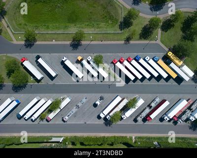 Eine Drohnenansicht des Parkens mit Lkw und Anhängern in der Nähe der Autobahn. Stockfoto