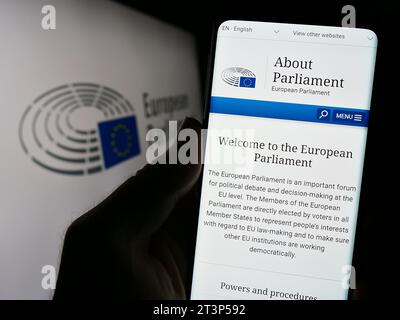 Person, die ein Mobiltelefon hält und die Website des EU-Gesetzgebungsorgans (EP) vor dem Logo zeigt. Konzentrieren Sie sich auf die Mitte des Telefondisplays. Stockfoto