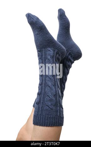 Weibliche Beine in dunkelblauen handgestrickten Kniestrümpfen aus Wolle isoliert auf weißem Hintergrund, Schneidepfad inbegriffen Stockfoto