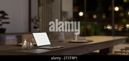 Seitenansicht eines Laptops mit weißem Bildschirm auf einem Esstisch in modernem, minimalem japanischen Esszimmerstil bei Nacht. 3D-Rendering, 3D-Abbildung Stockfoto