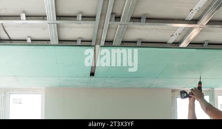 Drywall Installers. Men holding a gypsum board figured cut Stockfoto