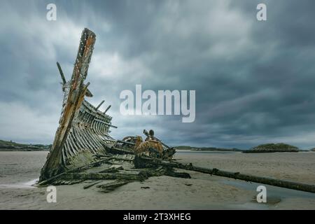 Bád Eddie, auch bekannt als Eddie's Boat, ist ein ikonisches Schiffswrack am Magheraclogher Beach in Gweedore, County Donegal, Irland. Stockfoto