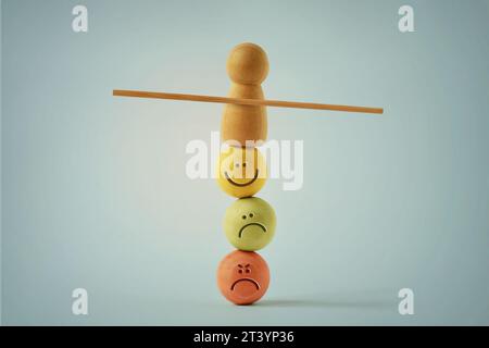 Holzbauernbalancierung auf Perlengesichtern mit unterschiedlichen Stimmungsausdrücken - Konzept des emotionalen und mentalen Gleichgewichts Stockfoto