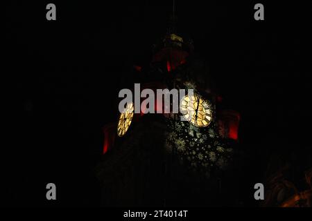 Beleuchteter Uhrenturm des Balmoral Hotels bei Nacht mit roten Lichtern und weißen Schneeflocken auf schwarzem Hintergrund. (Edinburgh, Schottland) Stockfoto