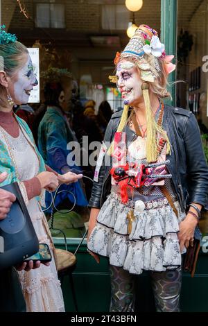 London, Großbritannien. Oktober 2023. Wir feiern den mexikanischen Tag der Toten in der Columbia Road im Osten Londons. Es ist zu einem Weg geworden, sich an die mexikanische Kultur zu erinnern und beinhaltet, dass sich Familie und Freunde treffen, um Respekt zu erweisen und sich an Freunde und Familienmitglieder zu erinnern, die gestorben sind. Diese Feierlichkeiten können einen humorvollen Ton annehmen, während die Prominenten sich an lustige Ereignisse und Anekdoten über die Verstorbenen erinnern. An diesem Tag wird angenommen, dass die Geister der Ahnen zurückkehren. Die Columbia Road ist berühmt für ihren Blumenmarkt, und Blumen sind ein wesentlicher Bestandteil dieser jährlichen Feier. Quelle: Mary-Lu Bakker/Alamy Live News Stockfoto