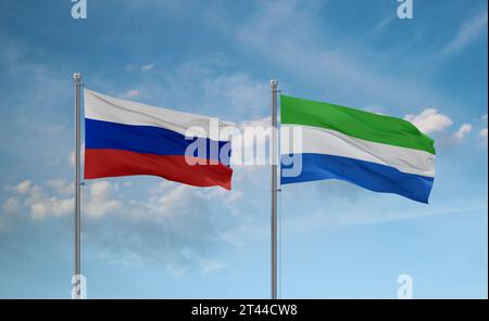 Sierra Leone oder Salone und Russland Fahnen, die zusammen im Wind auf blauem bewölktem Himmel winken, zwei Länder-Beziehungskonzept Stockfoto