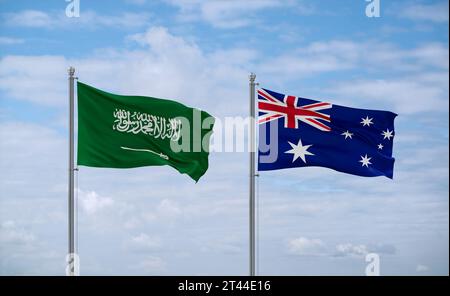 Australien und Saudi-Arabien Flaggen schwenken zusammen auf blauem bewölktem Himmel, zwei Länder-Beziehungskonzept Stockfoto