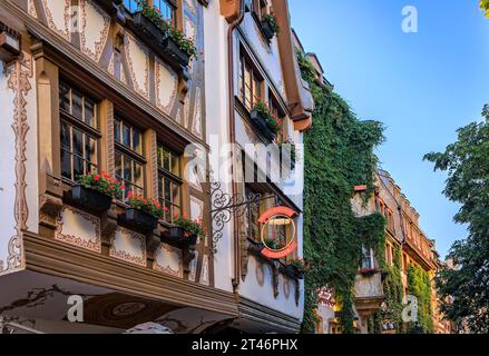 Straßburg, Frankreich - 31. Mai 2023: Kunstvolle Fassaden elsässischer Weinrestaurants in traditionellen Fachwerkhäusern im historischen Zentrum bei Sonnenuntergang Stockfoto