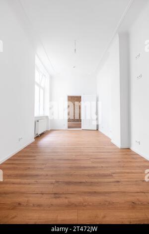 Leeres Zimmer mit Holzboden in neuer Wohnung nach der Renovierung Stockfoto