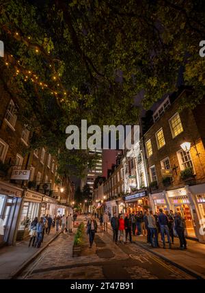 London, Großbritannien: Monmouth Street in der Nähe von Seven Dials im Covent Garden Viertel im Zentrum von London. Die Leute auf der Straße nachts. Stockfoto