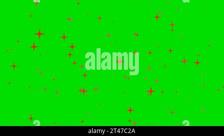 Bild des funkelnden roten Sterns mit Glitzer hinter grünem Hintergrund Stockfoto