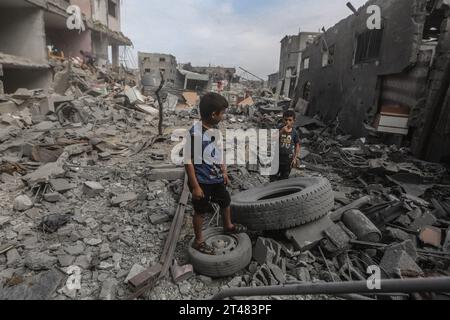 Al Bureij, Palästinensische Gebiete. Oktober 2023. Palästinensische Kinder stehen nach israelischen Luftangriffen in den Trümmern zerstörter Gebäude um die Al-Bilal-Moschee im Lager Al-Bureij. Quelle: Mohammed Talatene/dpa/Alamy Live News Stockfoto