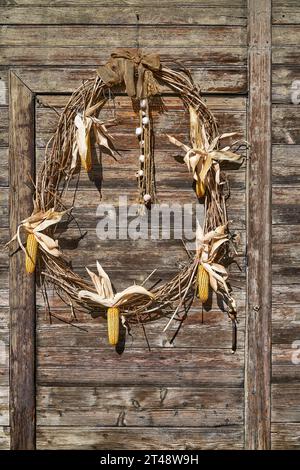 Herbstliche Türdekoration an einer Stalltür Stockfoto