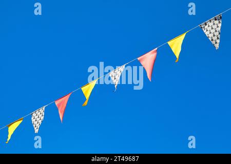 Dreieckige gelbe, rote und Hermelinfahnen in Guerlesquin, Bretagne. Stockfoto