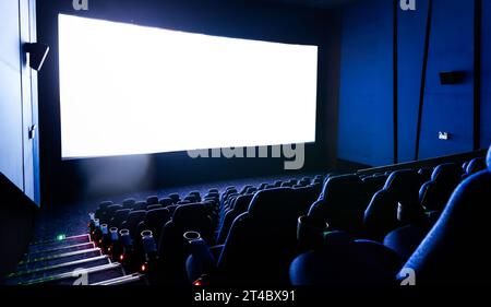Dunkles Kino mit Leinwand und Stühlen Stockfoto