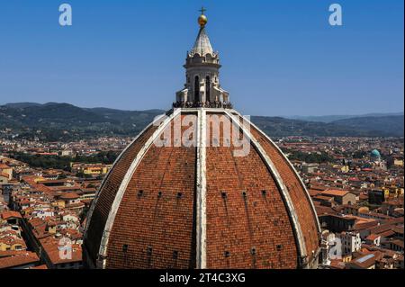 Laterne oder Turm aus weißem Marmor an der Spitze der achteckigen Kuppel der Kathedrale von Florenz in der Toskana, Italien. Die Aussichtsplattform am Fuße der Laterne befindet sich 90 Meter (295 Fuß) über dem Boden und bietet einen Panoramablick auf die Stadt und die umliegenden toskanischen Hügel. Das Äußere der Kuppel ist mit Terrakottafliesen bedeckt, die von acht Rippen aus weißem Marmor gekennzeichnet sind. Die Kuppel und die Laterne wurden zwischen 1420 und 1436 nach einem Entwurf von Filippo Brunelleschi (1377–1446) errichtet. Stockfoto