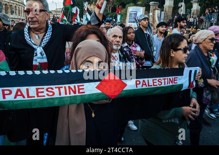 Rom, Italien. Oktober 2023. Eine Araberin hält während der Demonstration ein Banner. Palästinensische Verbände in Rom haben in der italienischen Hauptstadt einen Protest gegen den Krieg in Gaza und die Ermordung von Kindern organisiert. Sie treten auch für ein unabhängiges und freies Palästina ein. Rund 20.000 Menschen aus verschiedenen Teilen des Landes kamen bei diesem massiven friedensmarsch zusammen. Quelle: SOPA Images Limited/Alamy Live News Stockfoto