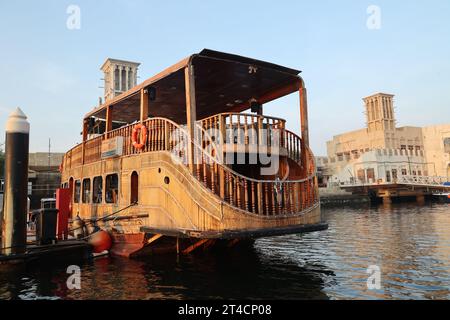 Oktober 2023, Dubai, VAE. Ein früher Morgen ab Dubai Abra mit traditionellem Gebäude und Booten. Es ist ein gewöhnlicher Mann-Reisemodus und für Touristen. Stockfoto