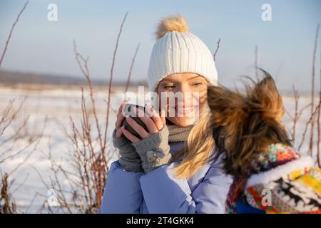 Die untergehende Sonne erleuchtet das lächelnde Gesicht einer jungen Frau. Stockfoto