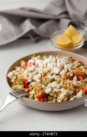 Quinoa-Salat mit Käse und frischem Gemüse auf einem Teller. Vegetarische Rezepte. Stockfoto