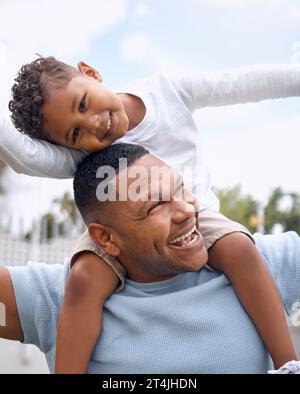 Ich kann sagen, dass Väter der Liebling hier sind. Ein Vater und ein Sohn, die sich zu Hause im Garten amüsieren. Stockfoto