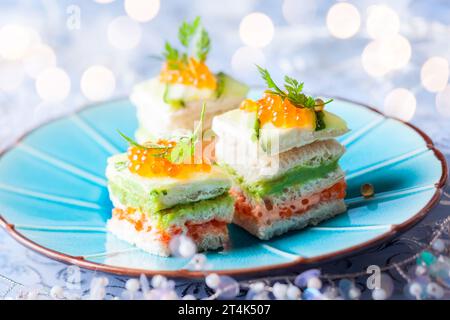 Gestreifte Sandwiches mit rotem Kaviar, Gurke und Avocado für den Urlaub Stockfoto