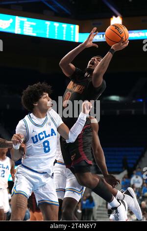 CAL State Dominguez Hills Toros Stürmer Jakob Alamudun (0) schießt den Ball gegen UCLA Bruins Forward Devin Williams (22) in der ersten Halbzeit während eines Basketballspiels der NCAA College am Dienstag, 31. Oktober 2023 in Los Angeles. Stockfoto