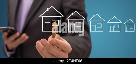 Geschäftsmann zeichnet ein Haus Stockfoto