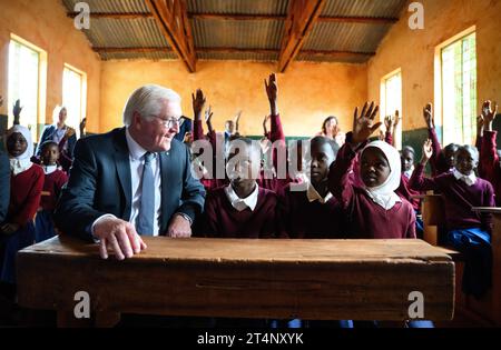 Songea, Tansania. November 2023. Bundespräsident Frank-Walter Steinmeier sitzt neben Schulmädchen in einer Klasse an der Maji-Maji Primary School in Songea. Er beendete seine Tansania-Reise am Mittwoch mit einem Beitrag zur Auseinandersetzung mit der deutschen Kolonialgeschichte und traf auch Familien in Songea, deren Vorfahren in einem brutalen Krieg in der Kolonie Deutsch-Ostafrika starben. Quelle: Bernd von Jutrczenka/dpa/Alamy Live News Stockfoto